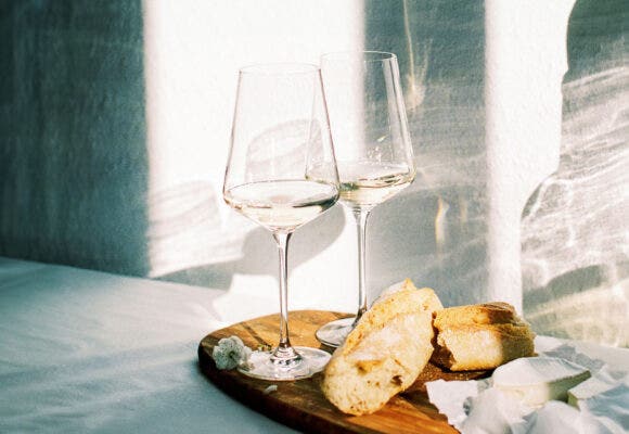 wine with fresh french bread and cheese during sunset time indoors