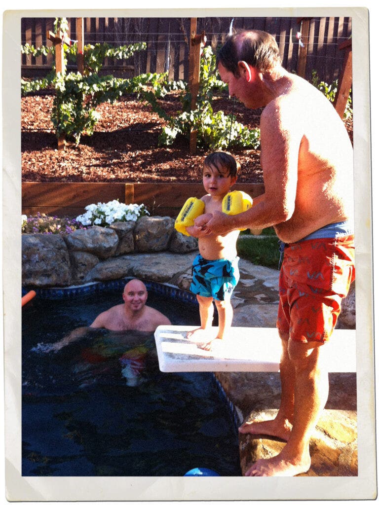 Three generations of Kettmanns (from left, Matt, Mason, and Dennis) in the pool with the East San Jose vines in the background.