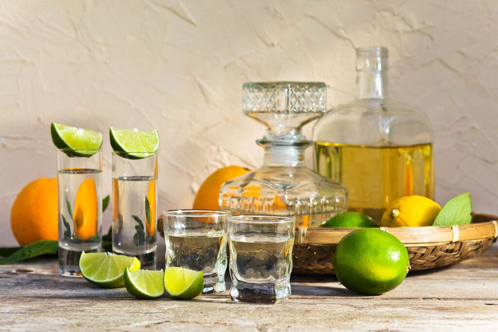 tequila and citrus fruits on a old table