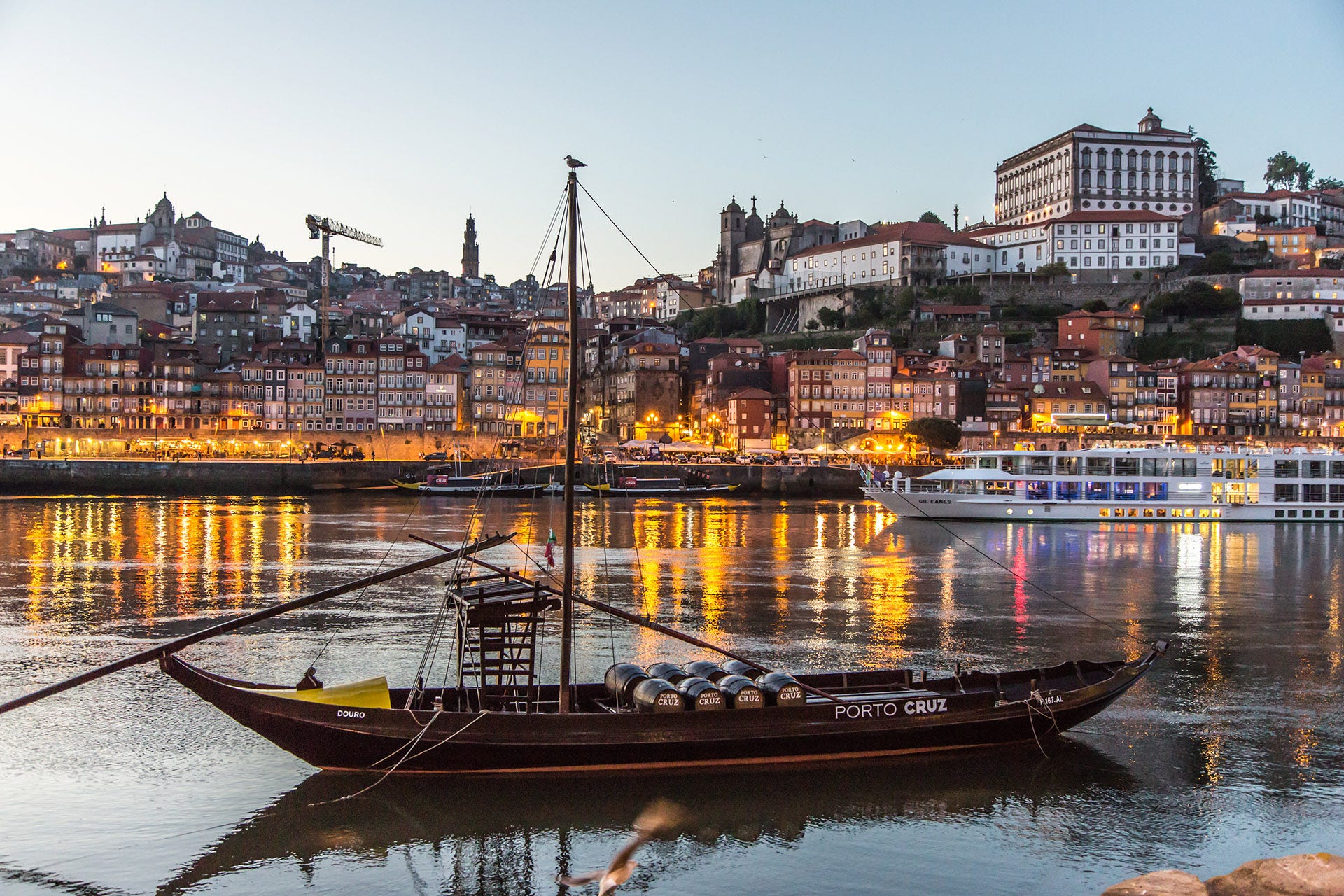 Historical Port Wine ship at river Douro with Oporto city in the evening, Oporto, Portugal